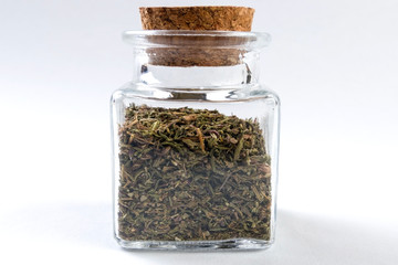 thyme herb in a glass jar isolated on white background