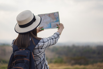 woman searching direction on location map while traveling