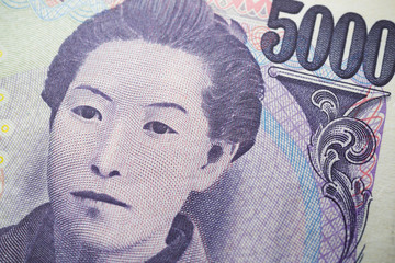 Close up macro of ichiyo higuchi on 5000 Japanese yen banknote texture background. Concept of Japanese yen payment currency of Japan, Forex investment, stock market or asia, global financial economic.