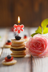Fruit, berry and pancake canapesFruit, berry and pancake canapes on white wooden table