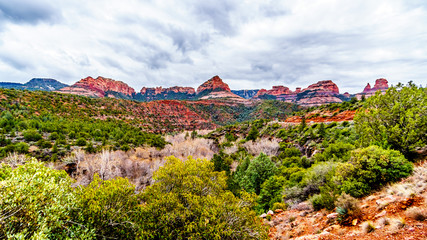 Fototapeta na wymiar Rain clouds hanging over the red rocks of Schnebly Hill and other red rocks at the Oak Creek Canyon viewed from Midgely Bridge on Arizona SR89A, between Sedona and Flagstaff in northern Arizona, USA