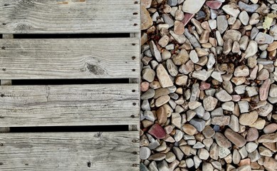 old wooden dock over colorful rocks
