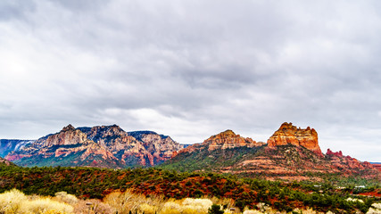 Rain clouds hanging over the red rocks of Schnebly Hill and other red rocks at the Oak Creek Canyon viewed from Midgely Bridge on Arizona SR89A, between Sedona and Flagstaff in northern Arizona, USA