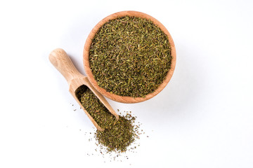 thyme herb in wooden bowl and scoop isolated on white background