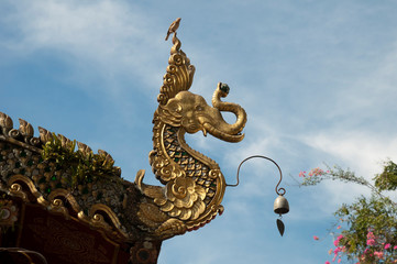 Fototapeta na wymiar Chiang Rai Thailand, carved mystical elephant serpent roof finial at wat ming muang