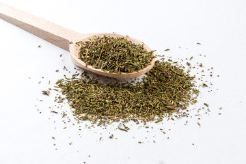 thyme herb in wooden spoon isolated on white background