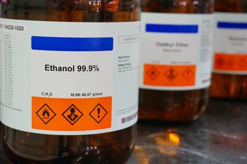 Bottle of Ethanol, C2H6O with Properties information and its chemical hazard warning symbols. Flammable symbol, Inhalation hazard symbol.
