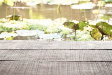 old wooden table and the lake with Asian tropical lake lotus  in background.nature.holiday.Asia