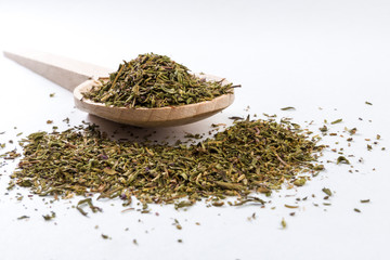 thyme herb in wooden spoon isolated on white background