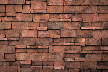 Old grunge brown stone brick wall texture abstract background.