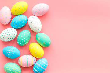 Easter composition. Decorated pastel Easter eggs on pink background top view space for text