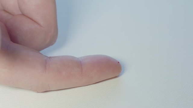 Male hands perform an at home blood sugar test close up