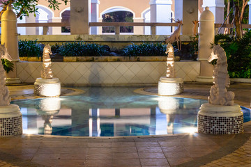 Luxury travel concept with executive swimming pool at night.