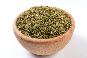 Fototapeta na wymiar marjoram herb in wooden bowl isolated on white background.
