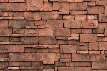 Old grunge brown stone brick wall texture abstract background.