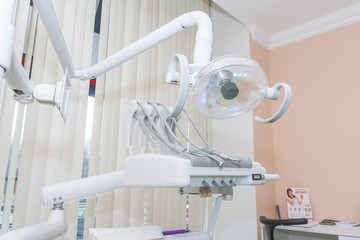 Dental office with dental chair.Dental light stand next to dental chair and tools in use for dentist. dental clinic office to treat patients with orthodontics. teeth care concept