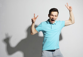 Fototapeta premium young man celebrating victory over white background