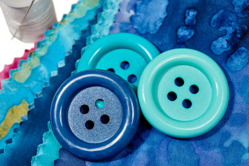 Multi-Colored Strips of Fabric with Large Buttons and Thread