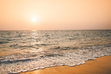 Tropical beach with sunset sky and cloud background.