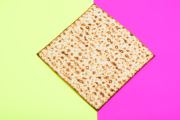 Matzah on bright festive background.Matza -Jewish traditional Passover unleavened  bread. Pesach celebration symbol.