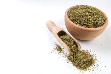 marjoram herb in wooden bowl and scoop isolated on white background. copy space added