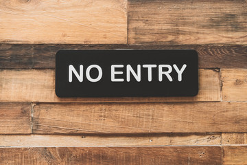 No entry sign on wood wall background.