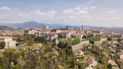 Fototapeta na wymiar Bergamo, Italy. Drone aerial view of the old town. Landscape at the city center, its historical buildings and the Venetian walls a Unesco world heritage