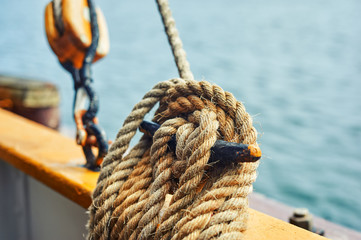 Close-up of mooring rope tied around the bollard by boat or ship
