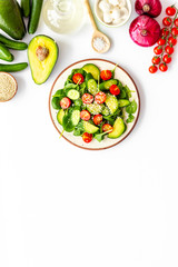 Preparing fresh salad. Vegetables, greens, spices on white background top view copy space