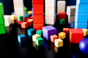 Obraz premium Toy wood blocks for Children to play with on black background