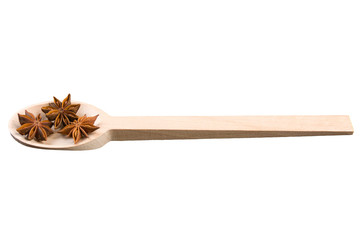 anise stars in wooden spoon isolated on white background