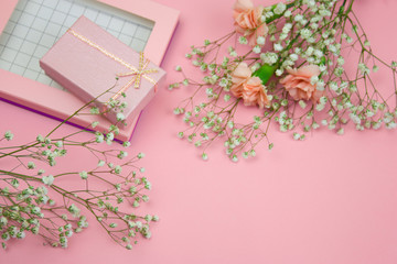top viewpink gift box and flowers on a pastel pink background
