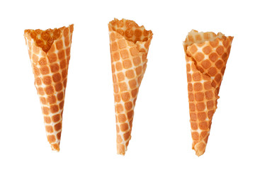 Three golden crispy ice-cream waffle cones on white background isolated closeup top view, empty appetizing ice cream wafer cup design, tasty homemade waffles cake, sweet summer dessert pattern concept