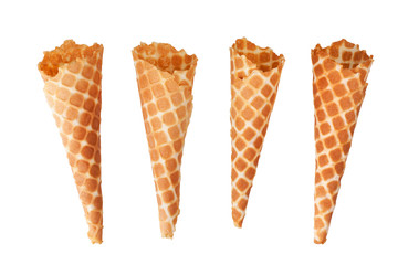 Four golden crispy ice-cream waffle cones on white background isolated close up top view, empty appetizing ice cream wafer cup design, tasty homemade waffles cake, sweet summer dessert pattern concept