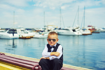 Little boy on a walk in the seaport