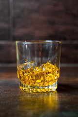 glasses of whiskey with ice cubes