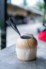 Close Up of Coconut water with blurred background and copyspace.