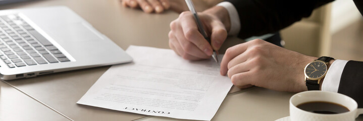 Closeup hands businessman sitting at desk accomplish meeting signing contract 