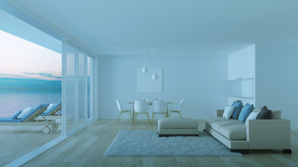 Interior of a villa with a swimming pool. House overlooking the sea. Night. Evening lighting. 3D rendering.