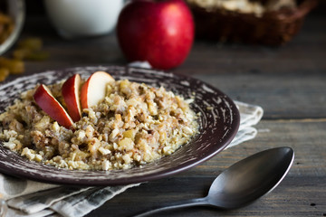 Buckwheat porridge with milk, apple, raisins and cashew nuts