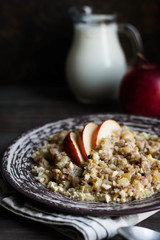 Buckwheat porridge with milk, apple, raisins and cashew nuts