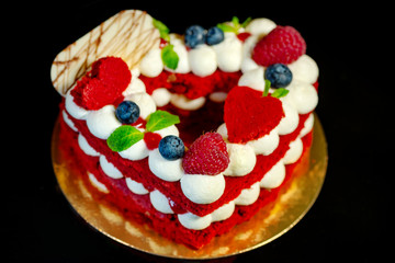 Red cake with berries on a black background