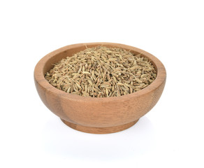 Caraway seeds in wooden bowl on white background