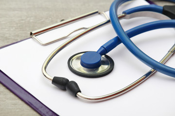 A stethoscope and a clipboard for notes as a medical check concept