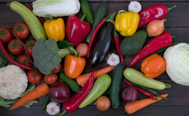Healthy food. Assorted fresh vegetables. View from above. Carrots, garlic, cabbage, onions, cucumber, chili pepper, sweet peppers, eggplant, Brussels sprouts, broccoli, avocado.