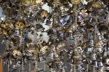 close up hanging small gold bells for luck in Wat Pongarkad , Chachoengsao , Thailand