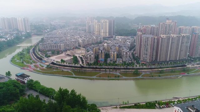 Aerial view of Songtao Miao Autonomous County, Guiyang, in Guizhou Province, China. Top view of rural city and canal with rowing team and boat racing. Top view around mountain with building and city.