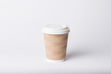 Paper cup with plastic lid on a white background. Hot drink concept, tea or coffee, takeaway