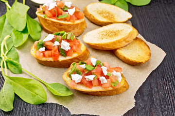Bruschetta with tomato and cheese on board