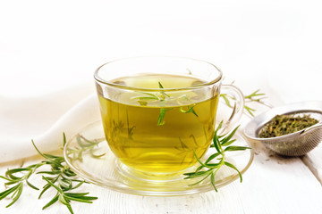 Tea of rosemary in cup with napkin on board